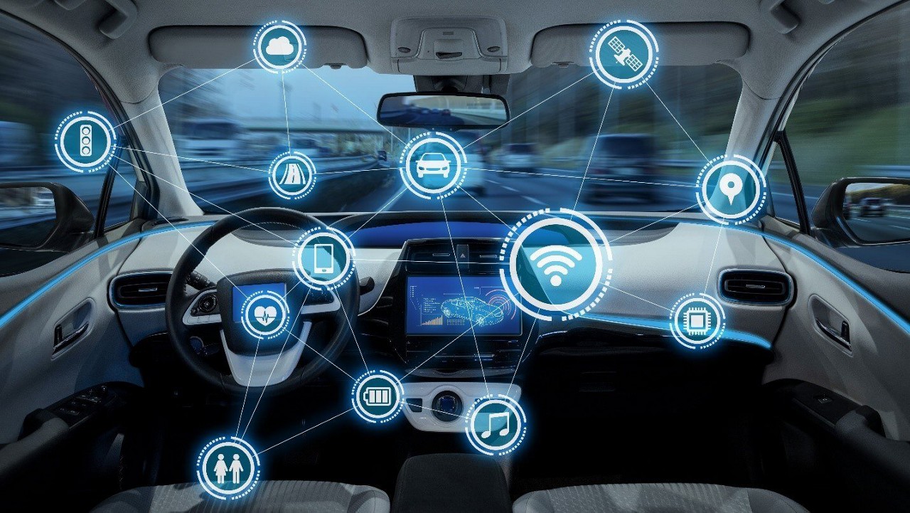 several cars on the road in background while showing the zoomed in image of one car interior