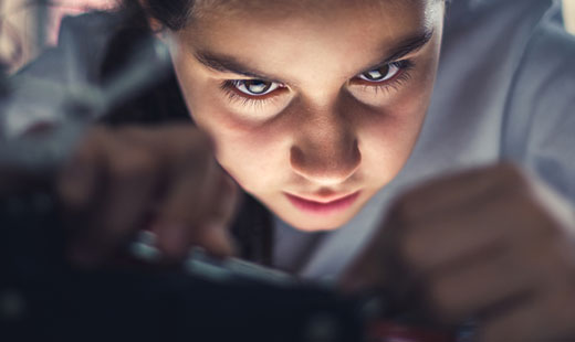close up of worker's face concentrating on a hands-on task that is blurred out